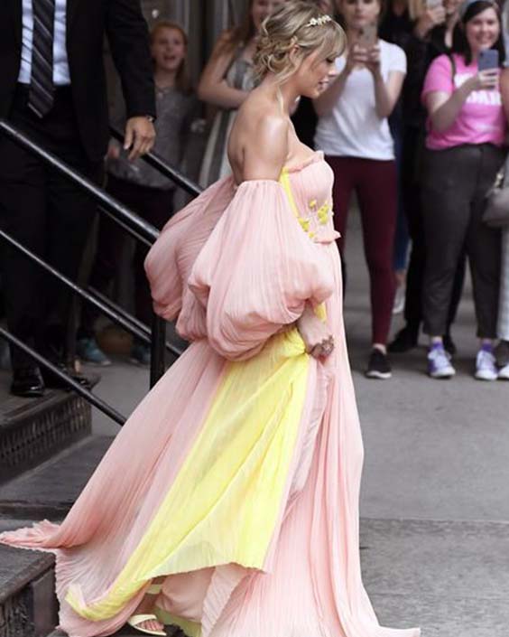 Taylor Swift in a pink and yellow dress lover era